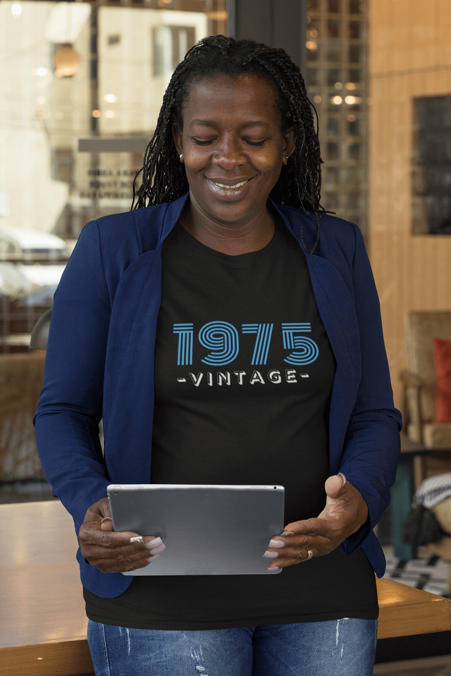 An African American Woman wearing a Black 1975 Birth Year Retro Tshirt