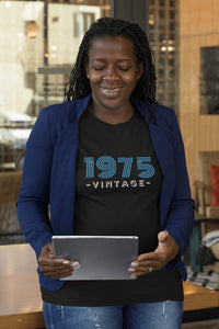 An African American Woman wearing a Black 1975 Birth Year Retro Tshirt